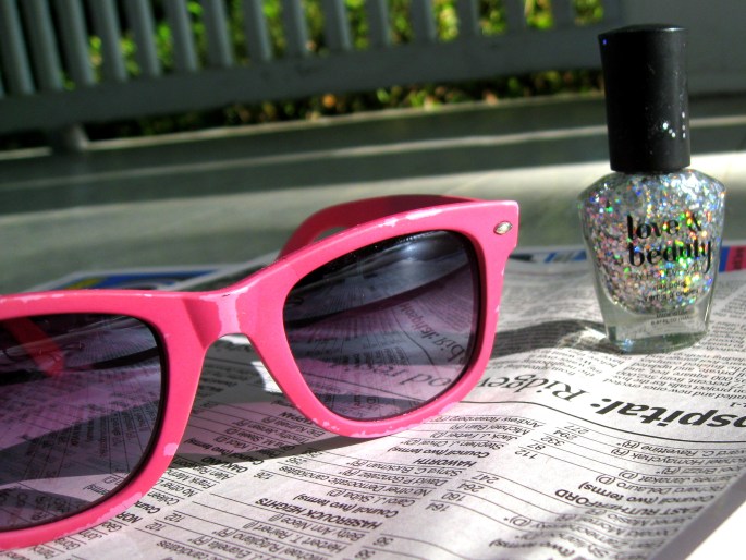 sunglasses and glitter nail polish